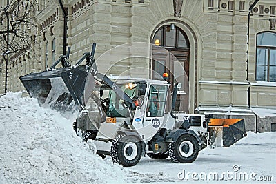 Snow Removal Tractor in City Editorial Stock Photo